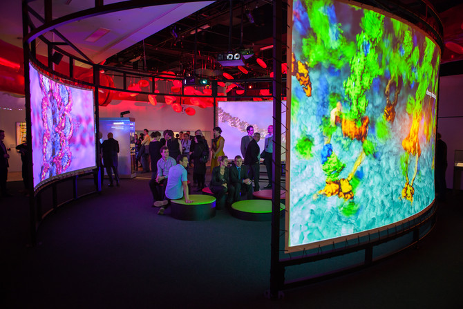 People watching projections in the BioMedical Breakthroughs exhibition during the stakeholder launch